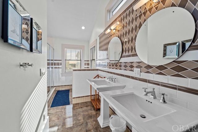 kitchen with light countertops, a sink, and tile walls