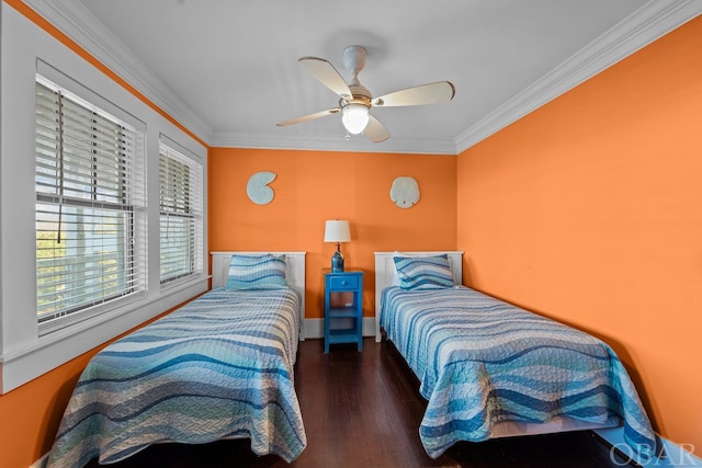 bedroom with a ceiling fan, baseboards, dark wood-type flooring, and crown molding