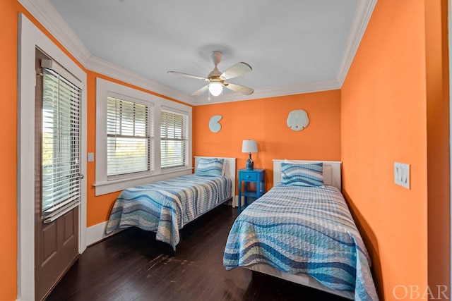 bedroom featuring ornamental molding, dark wood finished floors, a ceiling fan, and baseboards