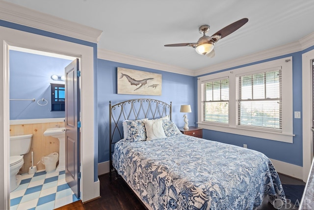 bedroom with ornamental molding, a ceiling fan, a sink, connected bathroom, and baseboards