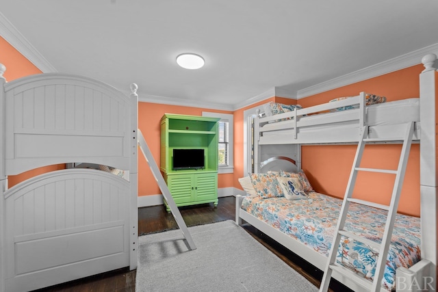 bedroom with dark wood-style floors, baseboards, and crown molding