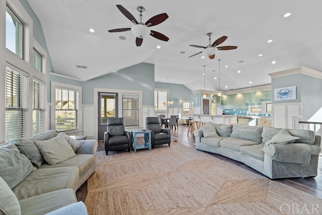 living area featuring high vaulted ceiling, visible vents, and wood finished floors