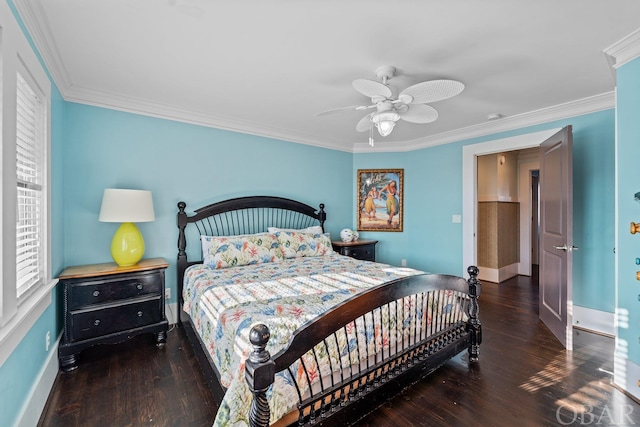 bedroom featuring crown molding, dark wood finished floors, and baseboards