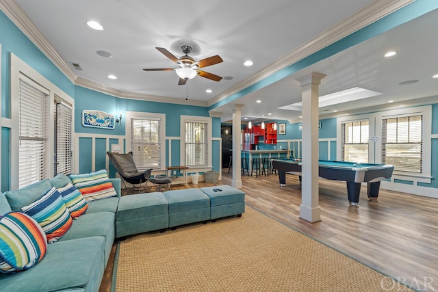 interior space with crown molding, pool table, visible vents, light wood-style flooring, and ornate columns