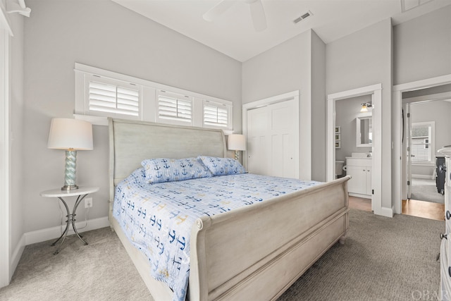 bedroom with ceiling fan, carpet flooring, visible vents, baseboards, and a closet