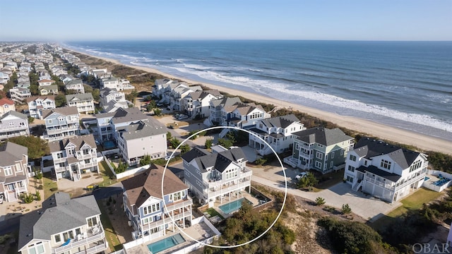 bird's eye view with a beach view, a water view, and a residential view