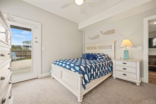 carpeted bedroom with baseboards, ceiling fan, and access to exterior