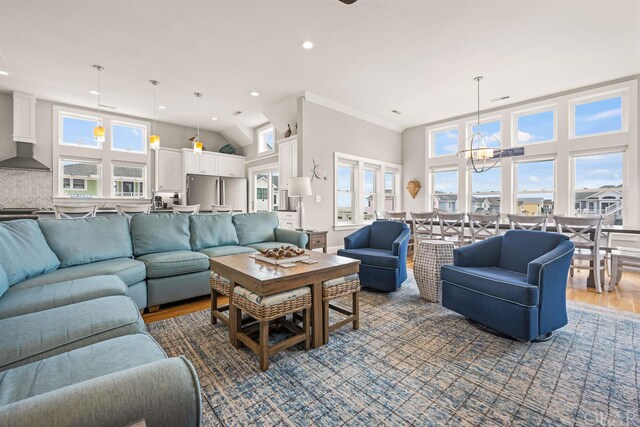 living area with a high ceiling, dark wood finished floors, a notable chandelier, and recessed lighting