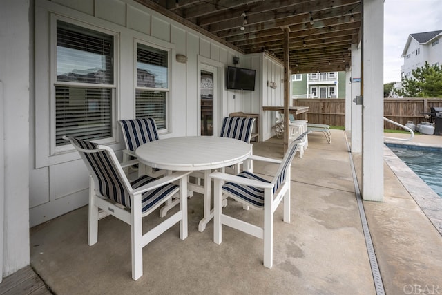 view of patio / terrace featuring fence, a fenced in pool, and outdoor dining space