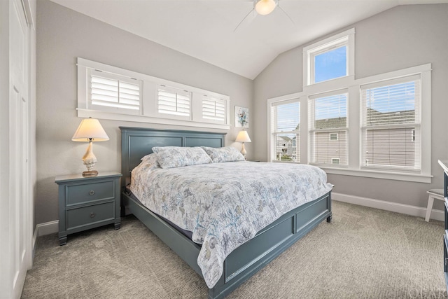 bedroom with lofted ceiling, light colored carpet, ceiling fan, and baseboards