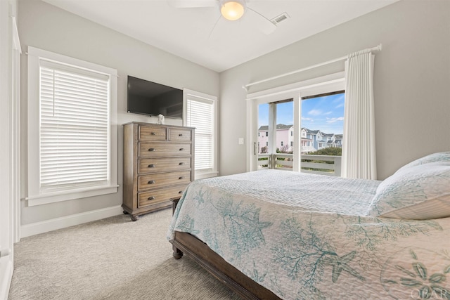 bedroom featuring light carpet, a ceiling fan, visible vents, and baseboards