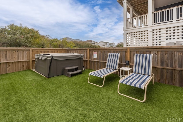 view of yard featuring a fenced backyard and a hot tub