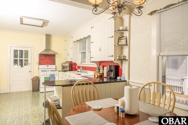505 N Broad St, Edenton, NC 27932 - kitchen featuring dark countertops, wall chimney exhaust hood, white gas stove, and ornamental molding