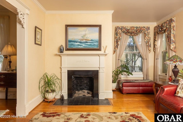 505 N Broad St, Edenton, NC 27932 - sitting room featuring baseboards, ornamental molding, a fireplace with flush hearth, and wood finished floors
