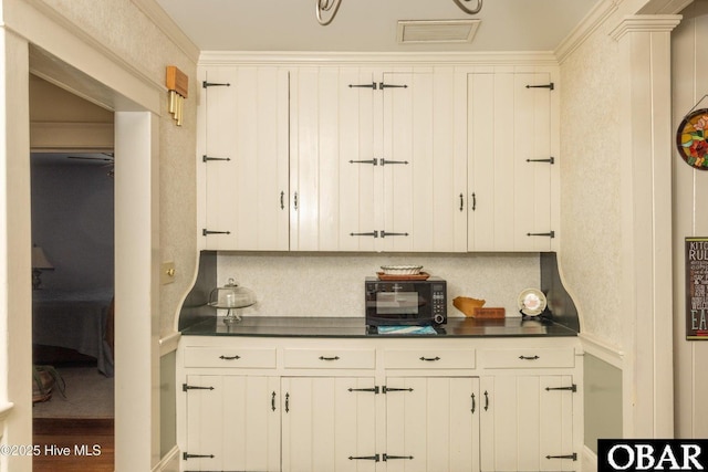 505 N Broad St, Edenton, NC 27932 - kitchen featuring dark countertops, white cabinets, and visible vents