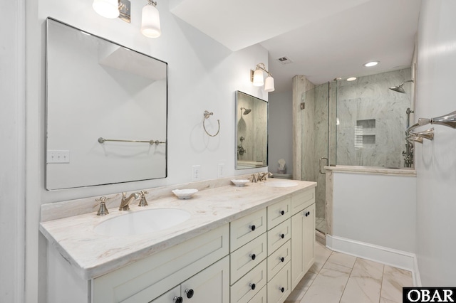 bathroom with a sink, a marble finish shower, marble finish floor, and double vanity