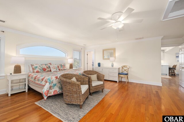 bedroom featuring crown molding, multiple windows, and wood finished floors