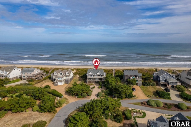 birds eye view of property with a view of the beach and a water view