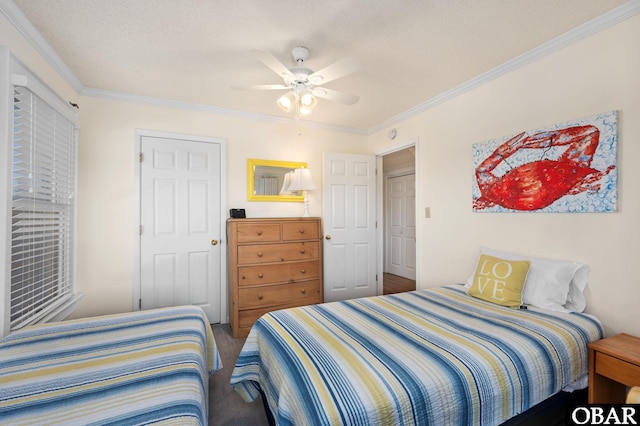 bedroom featuring ceiling fan, a textured ceiling, carpet, and ornamental molding