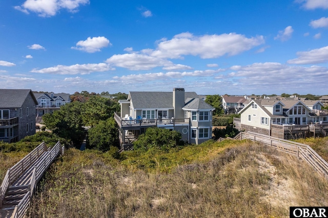 exterior space featuring a residential view, stairs, and fence