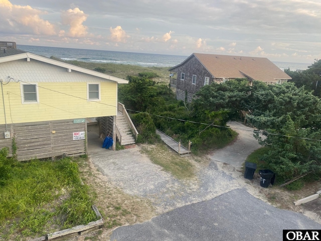 58221 Liberator Way Lot 1-3, Hatteras, NC 27943 - view of property exterior with stairway, asphalt driveway, and a water view