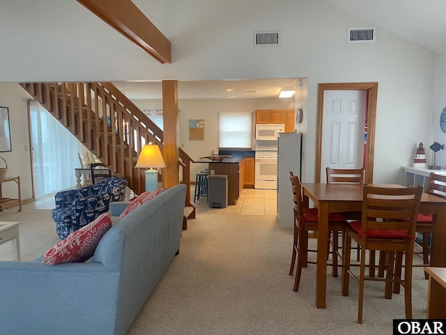 58221 Liberator Way Lot 1-3, Hatteras, NC 27943 - living room featuring light colored carpet, stairs, and high vaulted ceiling