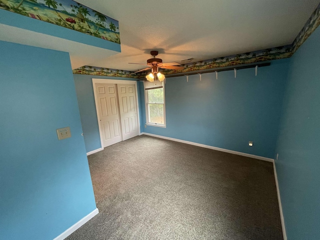unfurnished bedroom featuring a closet, baseboards, carpet, and a ceiling fan