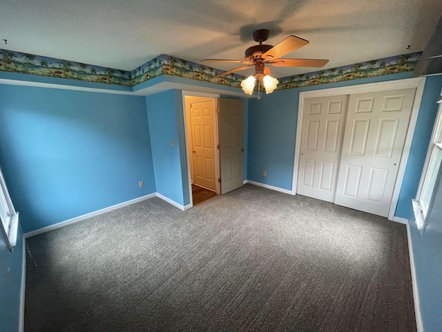 unfurnished bedroom with a closet, carpet floors, and baseboards
