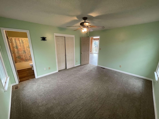 unfurnished bedroom featuring a closet, baseboards, carpet floors, and a textured ceiling