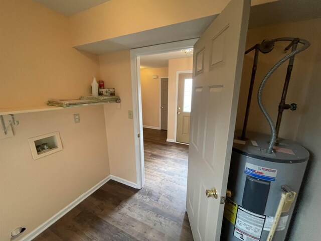 washroom featuring baseboards, gas water heater, washer hookup, laundry area, and wood finished floors
