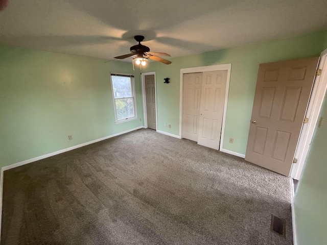 unfurnished bedroom featuring visible vents, baseboards, ceiling fan, a textured ceiling, and dark colored carpet