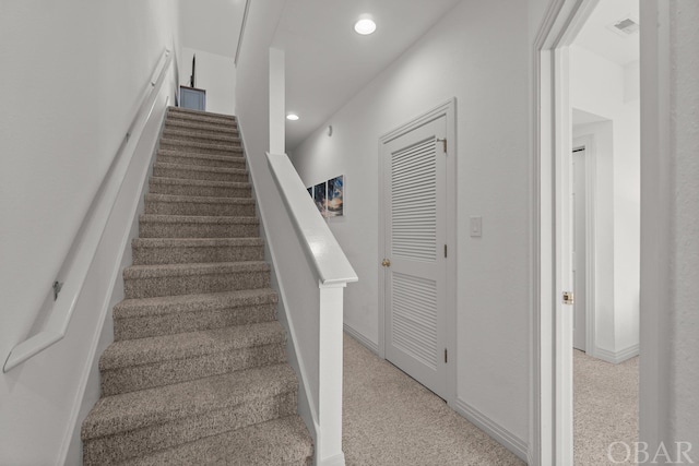 stairway featuring baseboards, carpet floors, visible vents, and recessed lighting