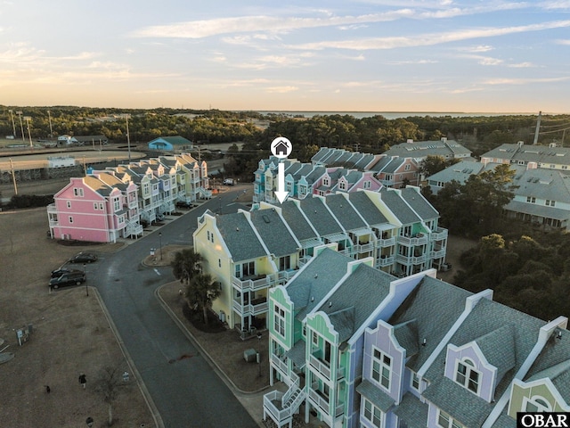 aerial view at dusk featuring a residential view