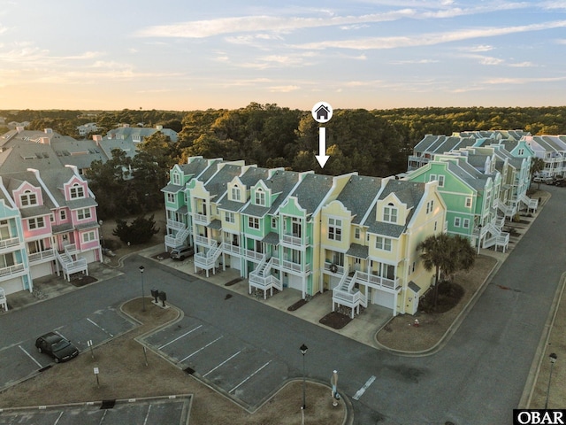 aerial view at dusk featuring a residential view