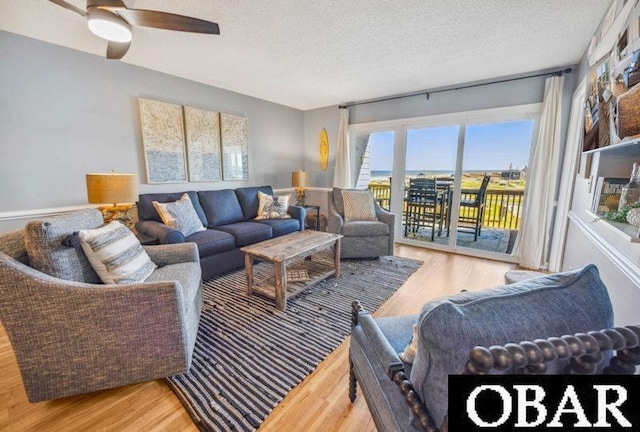 24250 Resort Rodanthe Dr Unit 12B, Rodanthe, NC 27968 - living area with wood finished floors, a textured ceiling, and a ceiling fan