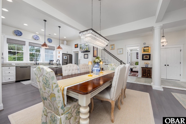 504 Lord Essex Ave, Manteo, NC 27954 - dining area featuring dark wood-style flooring, ornate columns, recessed lighting, and stairway