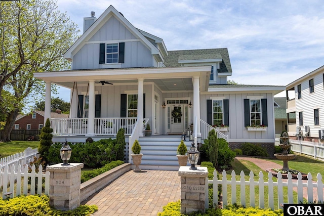 504 Lord Essex Ave, Manteo, NC 27954 - modern inspired farmhouse with board and batten siding, a porch, ceiling fan, fence private yard, and a shingled roof