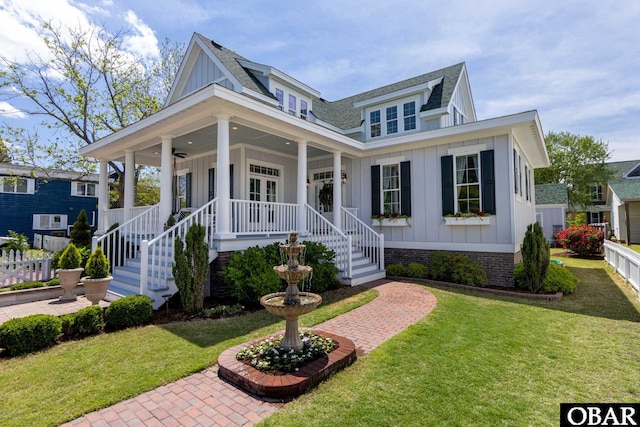 504 Lord Essex Ave, Manteo, NC 27954 - farmhouse featuring a front lawn, covered porch, french doors, a shingled roof, and board and batten siding