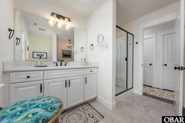 504 Lord Essex Ave, Manteo, NC 27954 - full bath with vanity, baseboards, a shower stall, and a notable chandelier