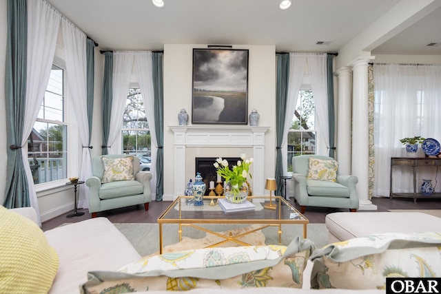 504 Lord Essex Ave, Manteo, NC 27954 - living area featuring a fireplace, recessed lighting, wood finished floors, ornate columns, and visible vents