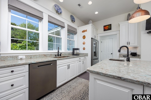 504 Lord Essex Ave, Manteo, NC 27954 - kitchen with stainless steel appliances, visible vents, white cabinetry, and a sink