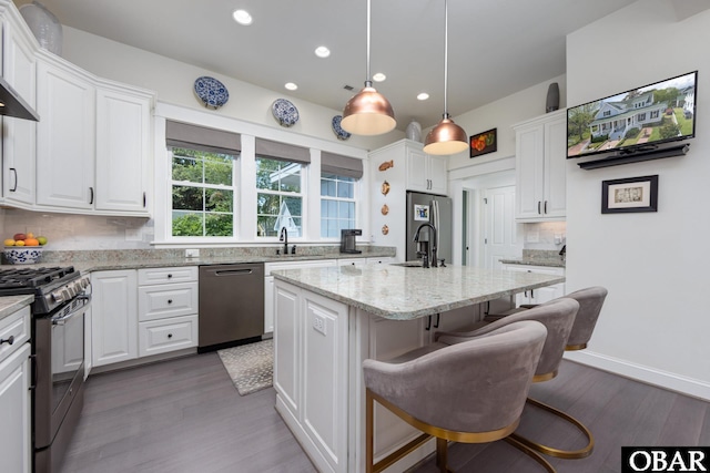 504 Lord Essex Ave, Manteo, NC 27954 - kitchen with a sink, decorative backsplash, appliances with stainless steel finishes, and white cabinetry