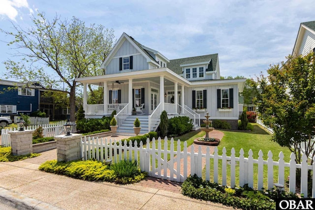 504 Lord Essex Ave, Manteo, NC 27954 - view of front of property featuring a fenced front yard, board and batten siding, covered porch, and a front yard