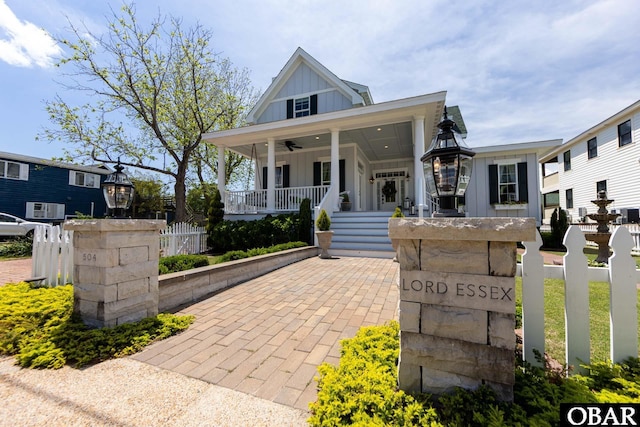 504 Lord Essex Ave, Manteo, NC 27954 - view of front facade with board and batten siding, a ceiling fan, and a porch
