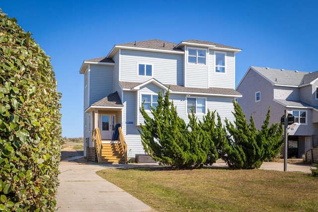 view of front of property with entry steps and a front yard