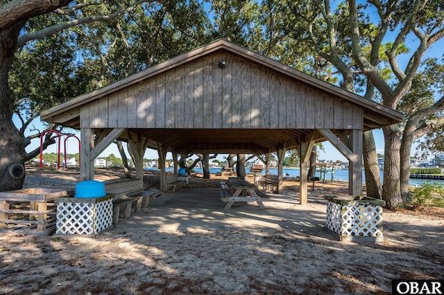 surrounding community with a gazebo and a water view