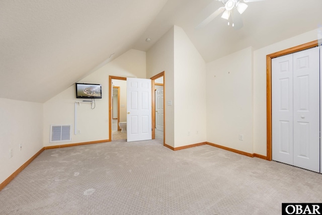 bonus room with a ceiling fan, carpet, visible vents, baseboards, and lofted ceiling