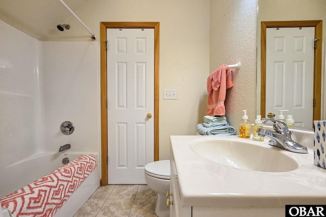 full bathroom with vanity, washtub / shower combination, tile patterned flooring, toilet, and a textured wall