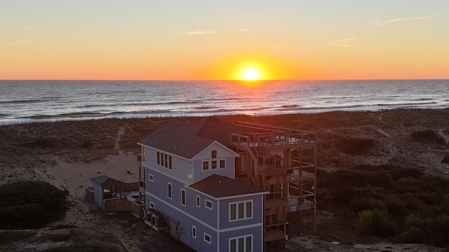 drone / aerial view with a water view and a beach view