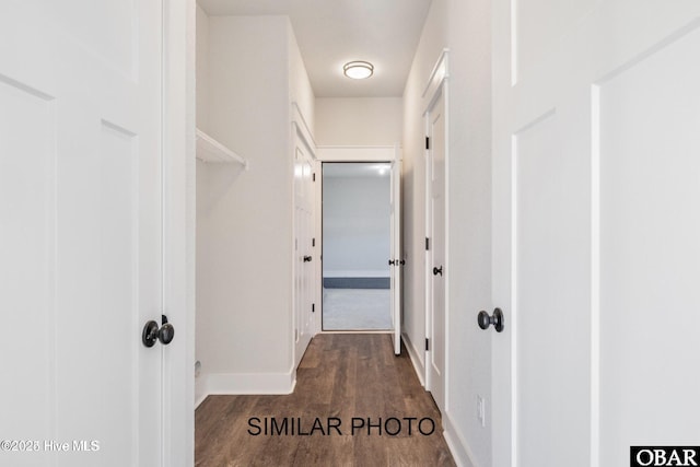 hall featuring dark wood finished floors and baseboards